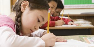 Girl doing school work in classroom